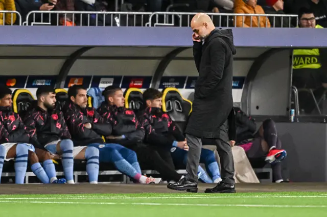 Pep Guardiola looks at the floor on the touchline