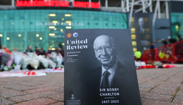 Manchester United matchday programme featuring Sir Bobby Charlton on the cover