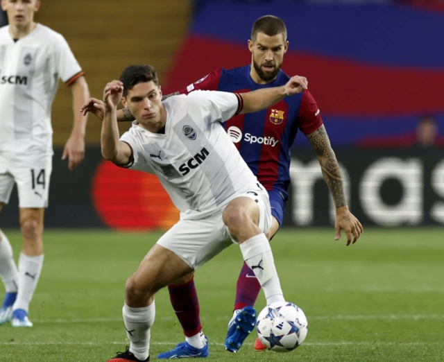 Shakhtar Donetsk's Georgiy Sudakov in action with FC Barcelona's Inigo Martinez