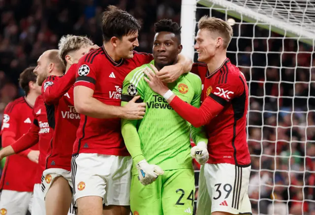 Andre Onana (centre) congratulated for his penalty save