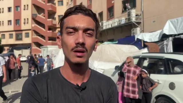 A man looks at the camera as he speaks