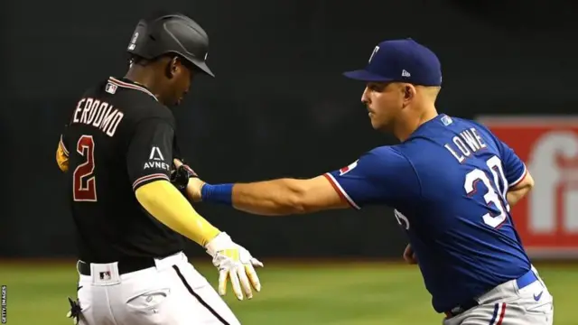 Geraldo Perdomo of the Arizona Diamondbacks and Nathaniel Lowe of the Texas Rangers