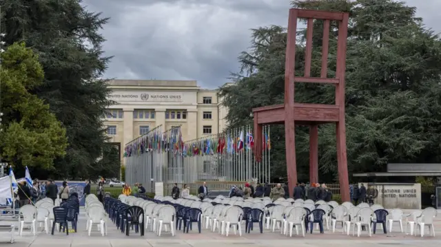 Rows and rows of plastic chairs are arranged outside the UN building