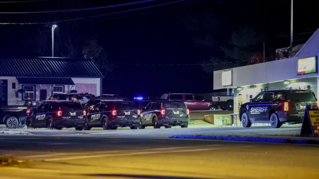 Law enforcement cars patrol as an active search for the shooter is underway in Lisbon following a mass shooting