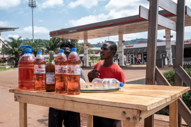 Fuel vendors set up their booth in front of the Total Marthyrs gas station that is closed because of a fuel shortage that has lasted several months in Bangui, on October 16, 2022.