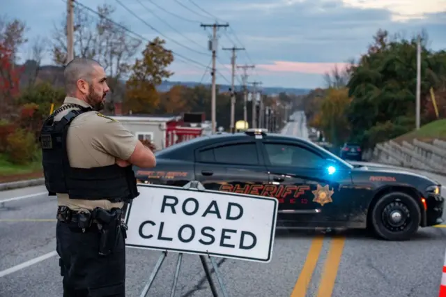 Police outside Schemengees Bar in Lewiston, one of the scenes of the mass shooting in Lewiston