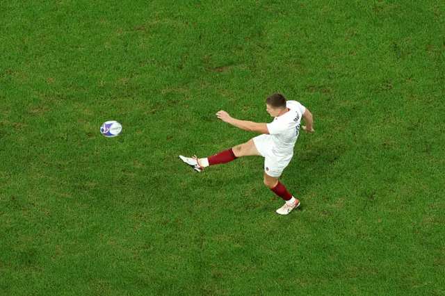 Owen Farrell kicks the ball out of hand