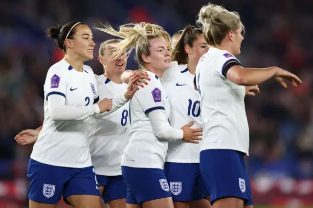 Lauren Hemp celebrates with team-mates after opening the scoring for England