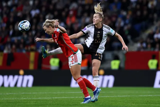 Gemma Evans of Wales battles for the ball with Laura Freigang of Germany