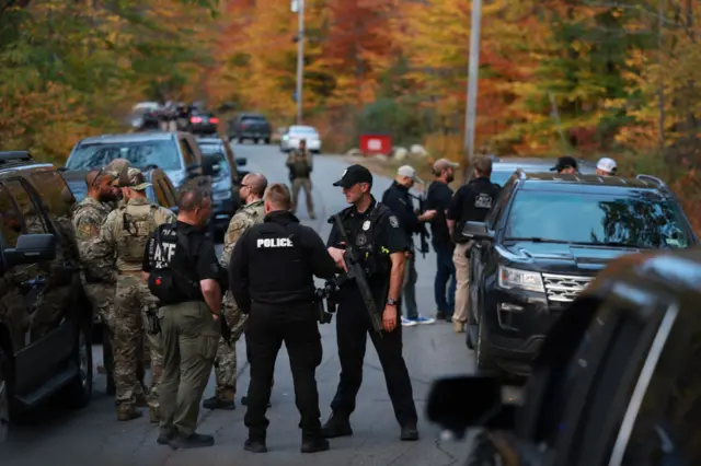 Armed police officers and their vehicles blocked roads as they carried out searches for the suspect in the area