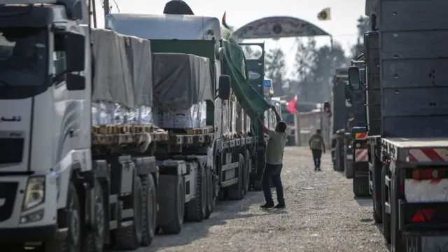 A convoy of lorries carrying humanitarian aid queues to enter the Gaza Strip from Egypt via the Rafah border crossing