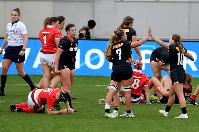 Canada players celebrate scoring a try against Wales