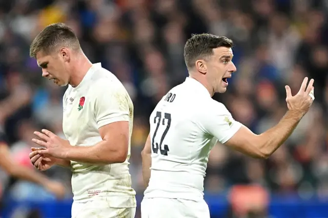 Owen Farrell of England looks on as teammate George Ford gives the team instructions