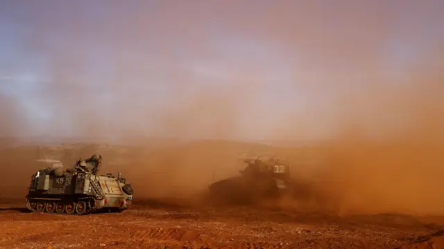 Israeli tanks participate in a drill near the border with Lebanon