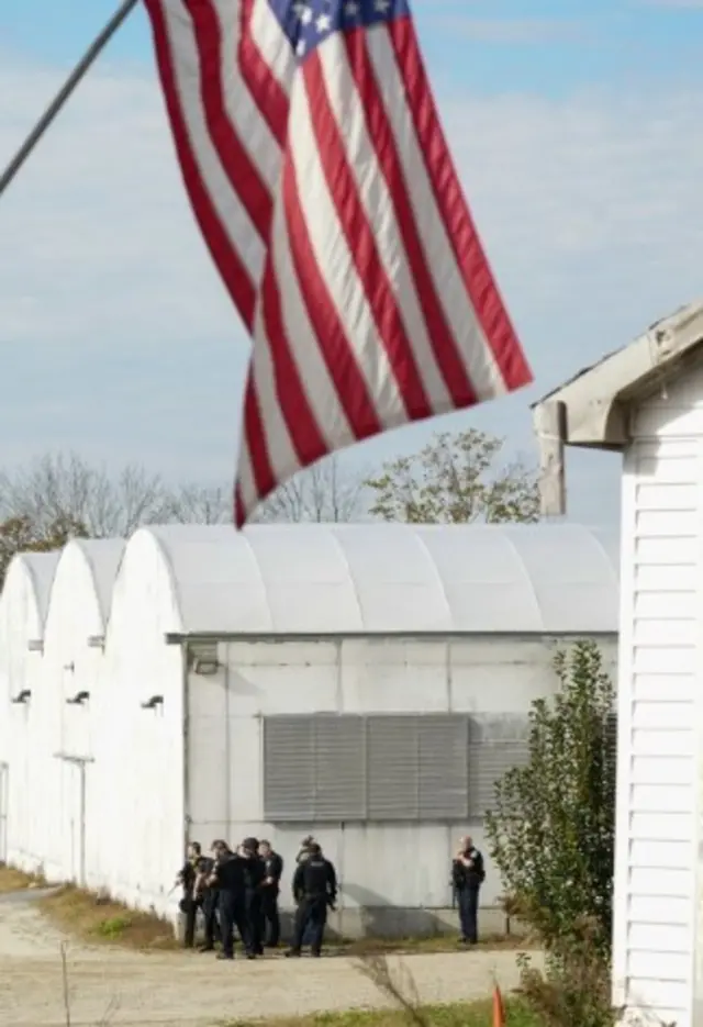 Police search a farm as the manhunt continues