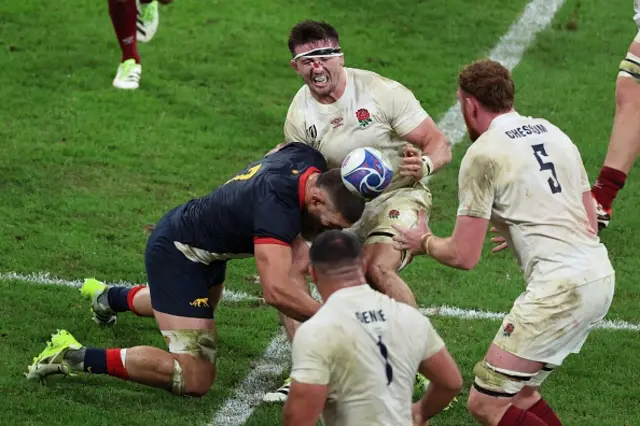 England's blindside flanker Tom Curry is tackled by Argentina's openside flanker Marcos Kremer