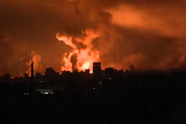 A screengrab from an AFP TV footage shows balls of fire and smoke rising above Gaza City