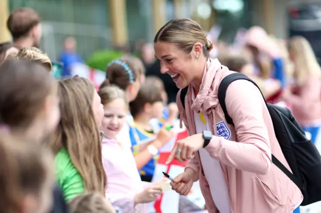 Mary Earps greets fans at St George's Park.