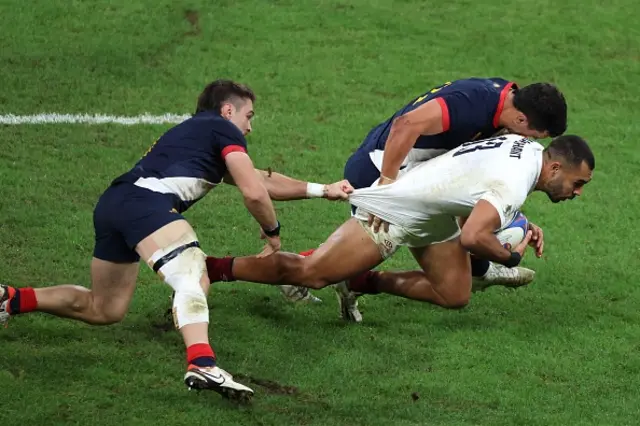 England's outside centre Joe Marchant is tackled by Argentina's left wing Mateo Carreras