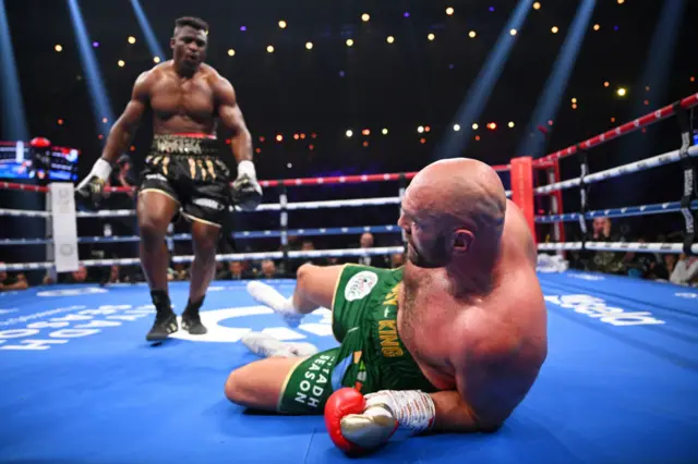 Francis Ngannou standing over Tyson Fury