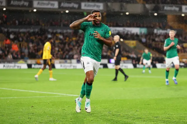 Wilson salutes the away fans by means of celebrating his goal.