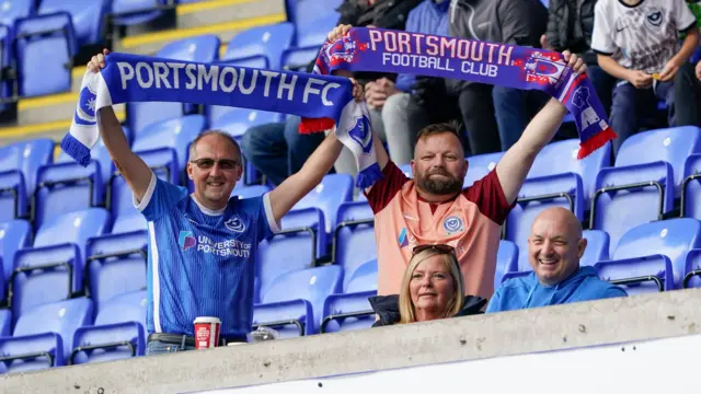 Portsmouth fans hold up scarves