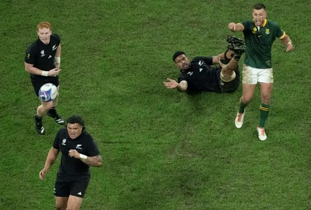 Savea on the floor with Pollard standing