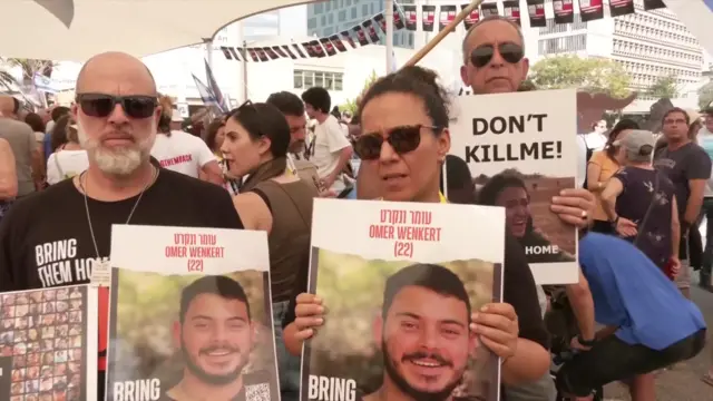 People in Tel Aviv holding posters with pictures of hostages being held by Hamas.