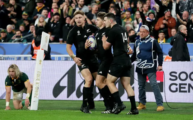 Jordie Barrett celebrates with teammates Beauden Barrett's try