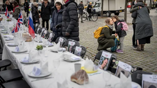 A Shabbat table with a place for each of the 222 people who were taken hostage by Hamas is set up at Kongens Nytorv in Copenhagen, Denmark, 27 October 2023.