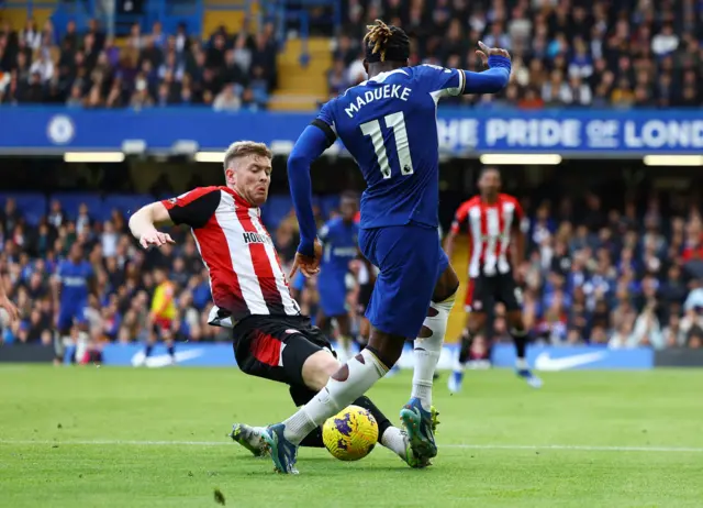 Brentford's Nathan Collins tackles Noni Madueke