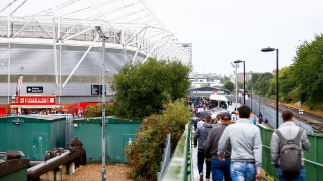 Southampton fans walking over the train bridge toward St Mary's.