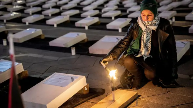 Mock coffins are on display during the memorial service 'Children pay the price' in support of the children in Gaza at City Hall Square in Copenhagen, Denmark, 27 October 2023