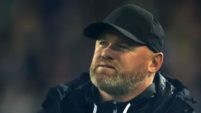 A frustrated Wayne Rooney walks the touchline during a match.