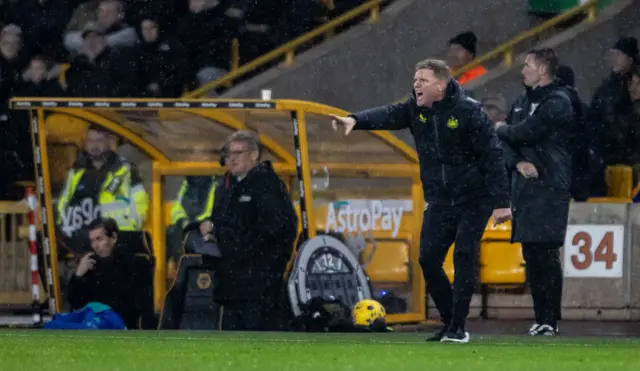 Eddie Howe shouts and points instructions from the sideline.