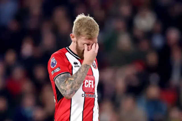 Ollie McBurnie covers his eyes in frustration.