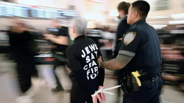 NYPD officers arrest a protester during a demonstration calling for a ceasefire amid war between Israel and Hamas, at Grand Central Station in New York City on October 27, 2023.