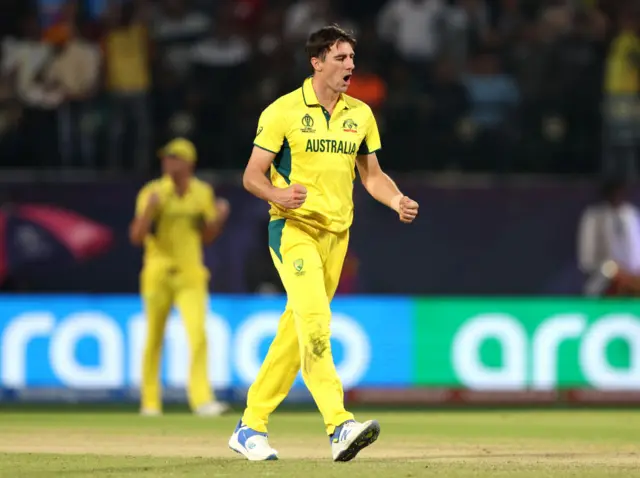 Pat Cummins celebrates the wicket of Rachin Ravindra