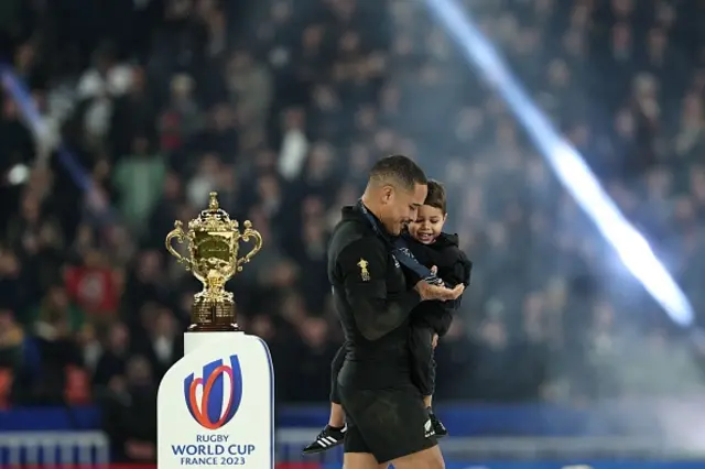 Aaron Smith walks past the Webb Ellis Cup