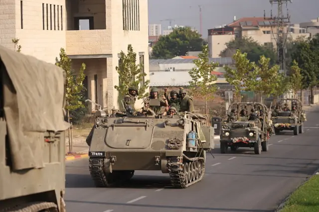 Israeli tanks and troops move near the border with Gaza on October 28, 2023 in Sderot, Israel