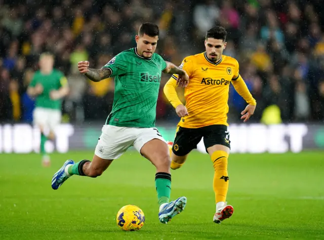 Guimaraes tries to run past Neto on the wing.