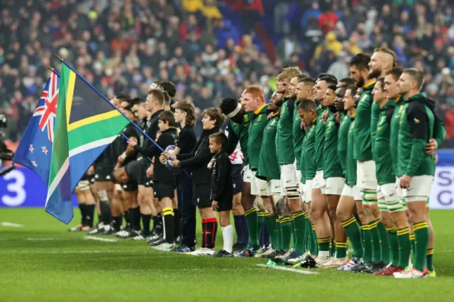 Both teams line up for the national anthems