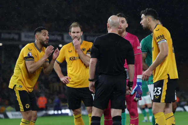 Wolves players complain to the referee Simon Hooper.