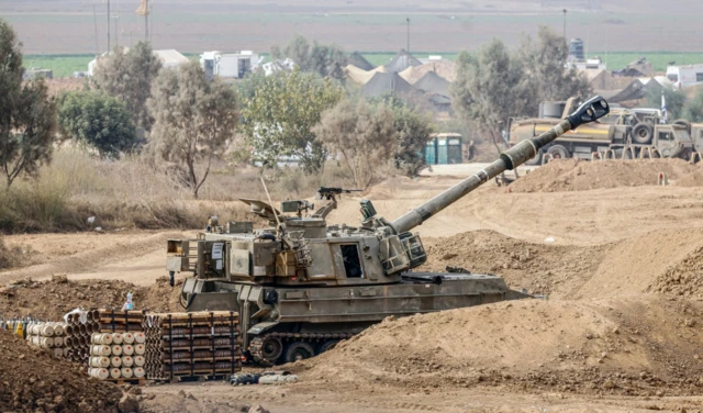 A 155 mm howitzer stands at a positon as the Israel Defense Forces (IDF) prepares for the scenario of ground manoeuvres at an undisclosed location near the border with Gaza