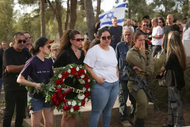 Mourners attend the funeral of Lili Itamari, 63, and Ram Itamari, 56, a couple from Kibbutz Kfar Aza