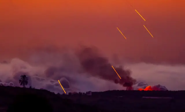 Israeli shells strike the northern part of the Gaza Strip during sunset, 29 October 2023.