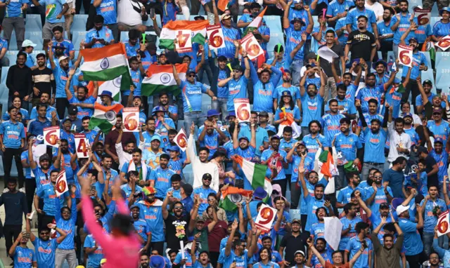 India fans celebrate a six