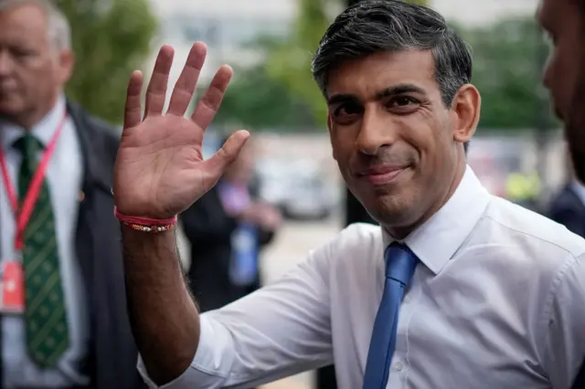 Sunak waves during the first day of the Conservative Party conference