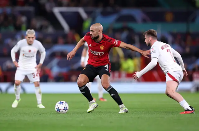 Sofyan Amrabat of Manchester United holds off Muhammed Kerem Akturkoglu