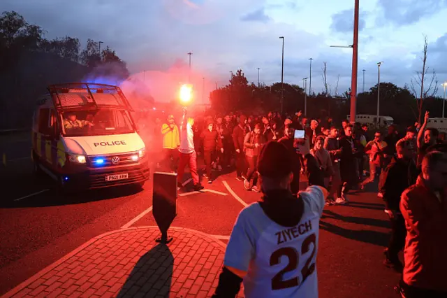 Police officers escort the Galatasaray fans to Old Trafford